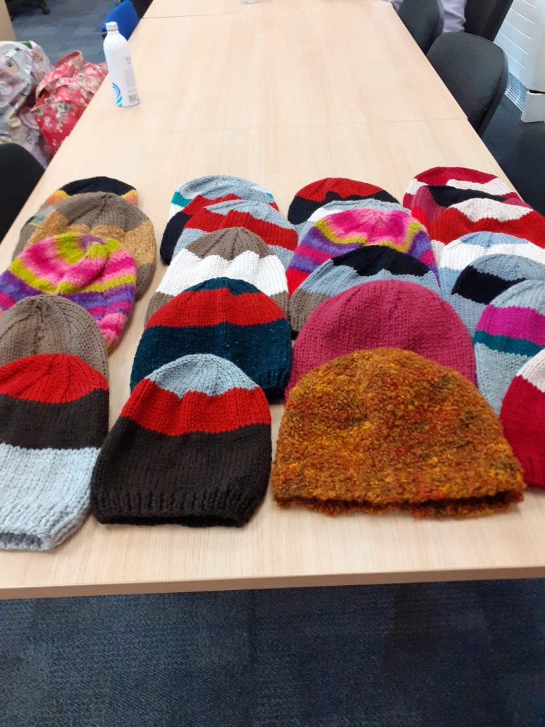 Hand knitted hats artistically laid across the table.